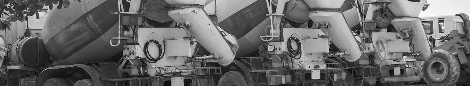 Heavy concrete truck on construction site against blue sky
